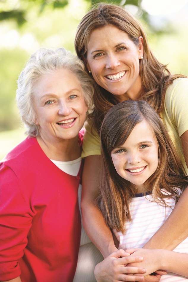 Three generations, grandmother, mother, and daughter, pose together
