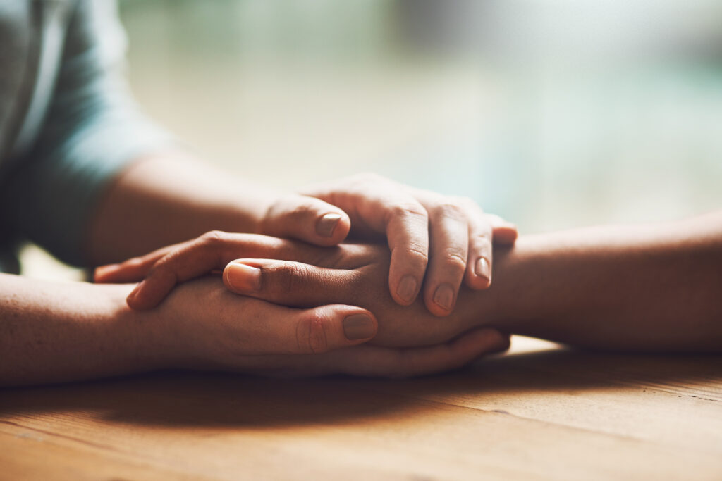 One person comforts another.