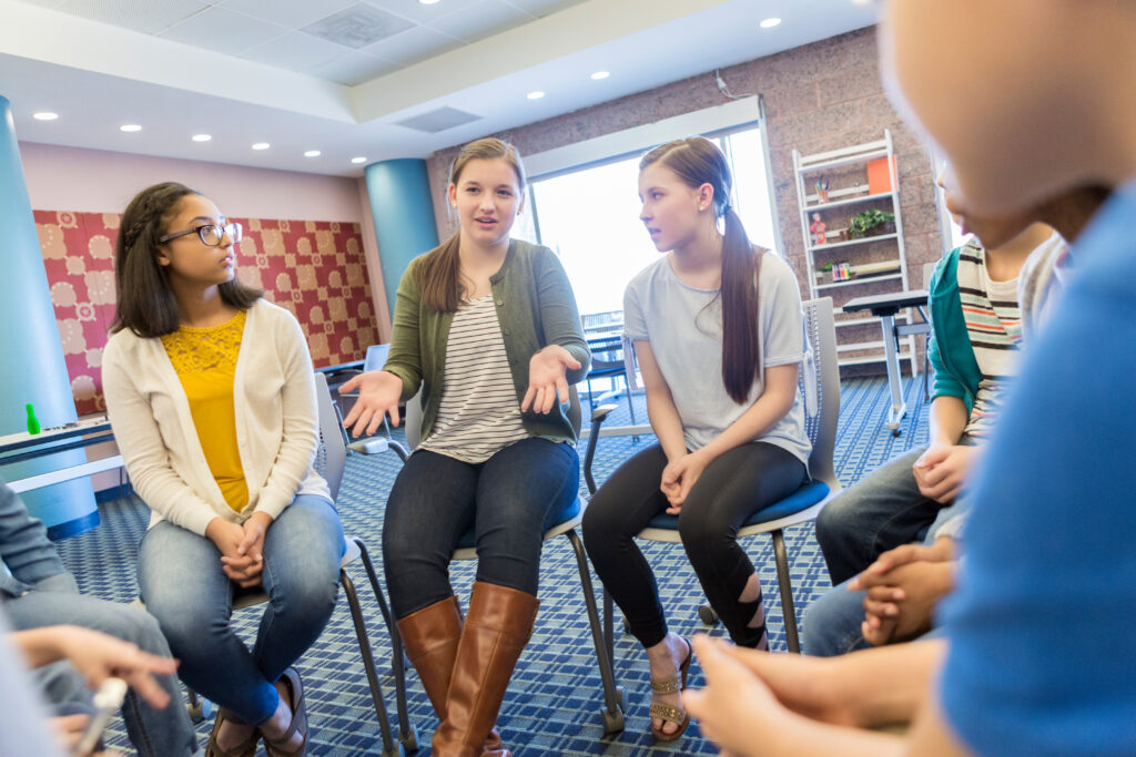 Teens talking together in a classroom